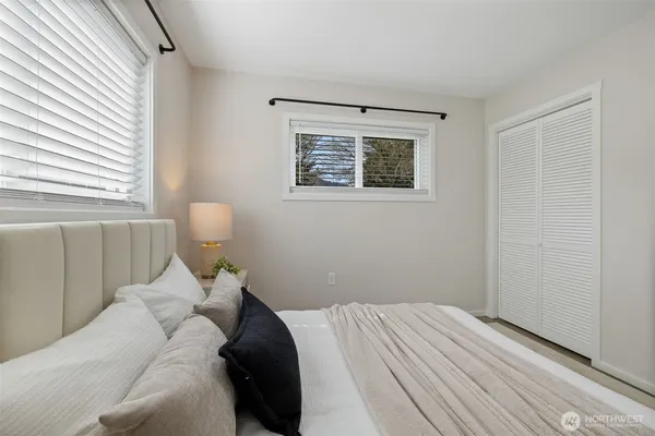 a bed room with a bed and a window