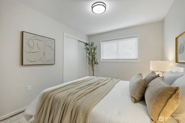 a bedroom with a bed and a painting on the wall