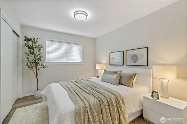 a bedroom with a bed and a potted plant