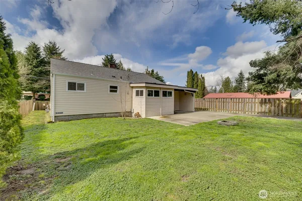 a view of a backyard with small cabin