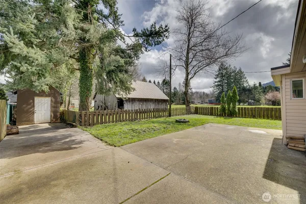 a view of a back yard of the house and a fountain