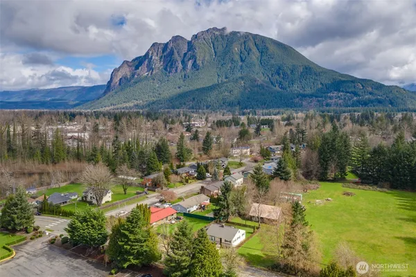 an aerial view of a house with swimming pool garden and mountain view