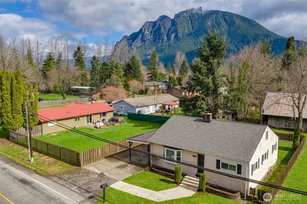 an aerial view of a house with garden space and street view