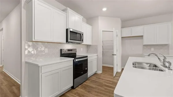 a kitchen with a sink a stove and refrigerator