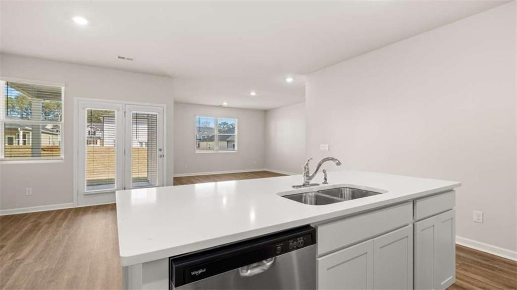 310 Friendship Oak Way Hampton, GA 30228 - Photo 13 of 41 a kitchen with kitchen island a sink and wooden floor