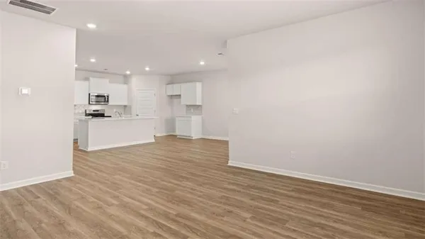 a view of a kitchen with a sink and wooden floor