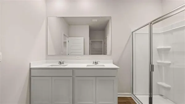 a bathroom with a double vanity sink mirror and