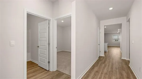 a view of a hallway with wooden floor