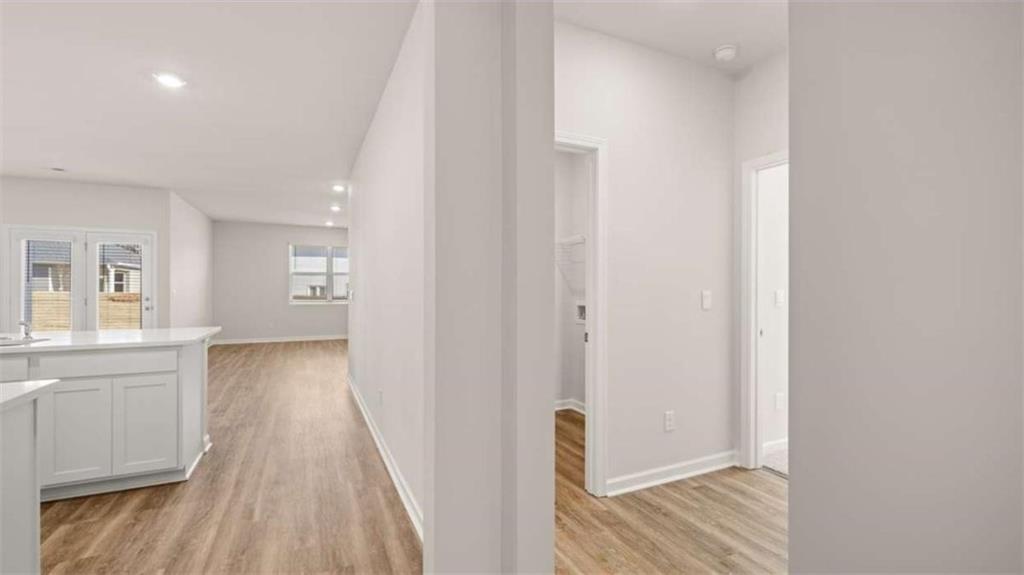 310 Friendship Oak Way Hampton, GA 30228 - Photo 7 of 41 a view of a hallway with wooden floor and a bathroom