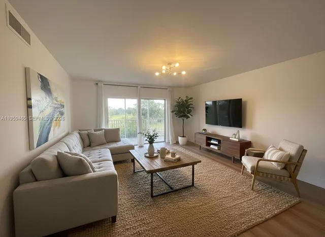 a living room with furniture and a flat screen tv