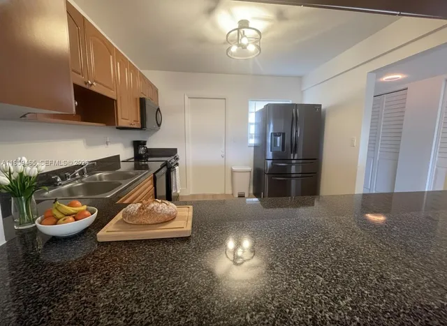 a kitchen with a refrigerator and a stove