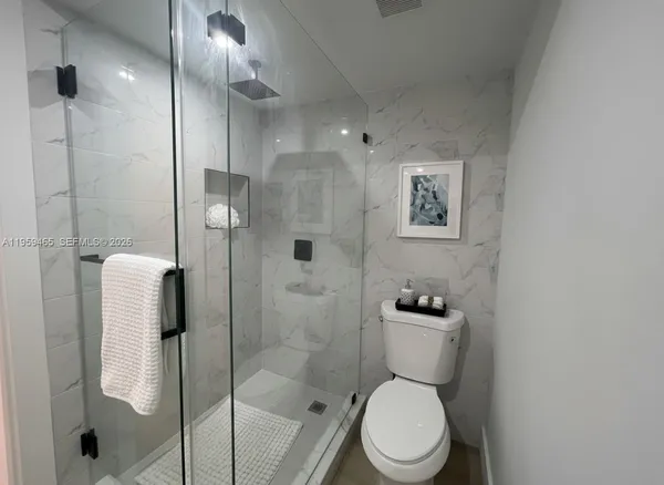 a bathroom with a toilet and a shower