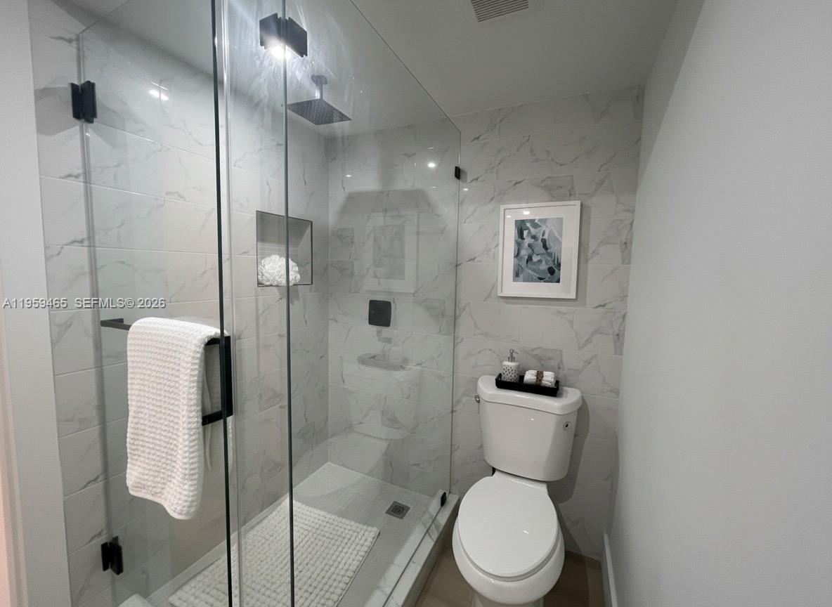 5100 Southwest 90th Avenue, Unit 302 Cooper City, FL 33328 - Photo 8 of 11 a bathroom with a toilet and a shower