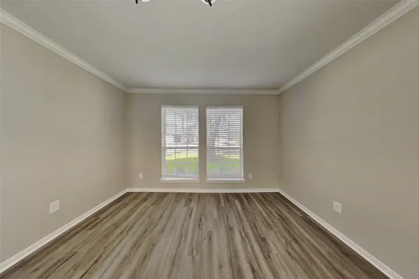 a view of a room with wooden floor and window