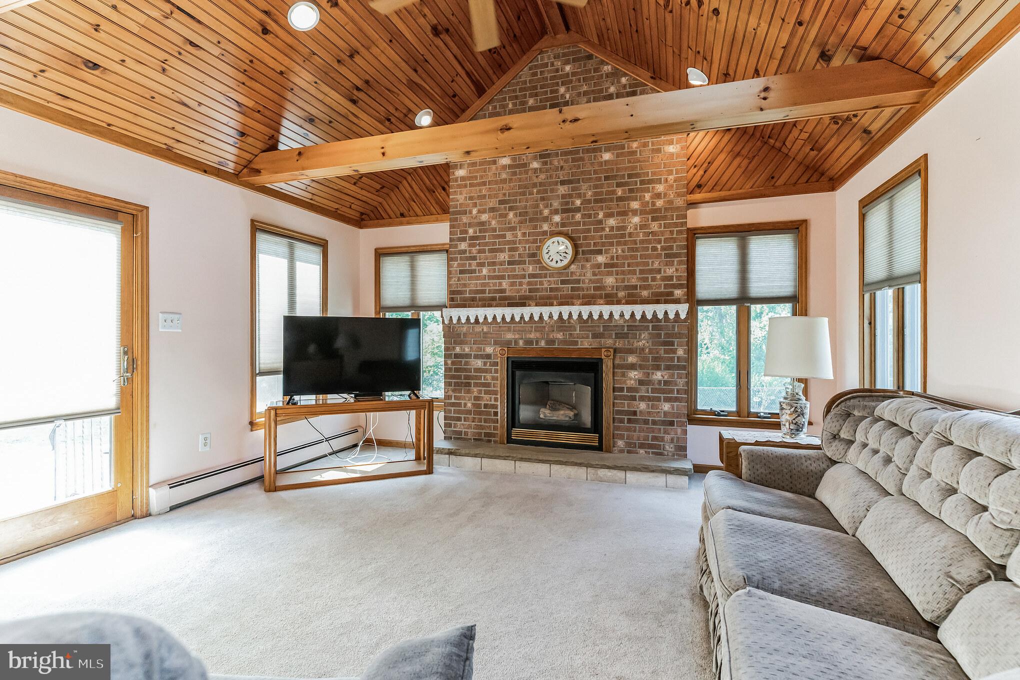 1776 Church Road Southampton, NJ 08088 - Photo 12 of 32 a living room with furniture a flat screen tv and a fireplace
