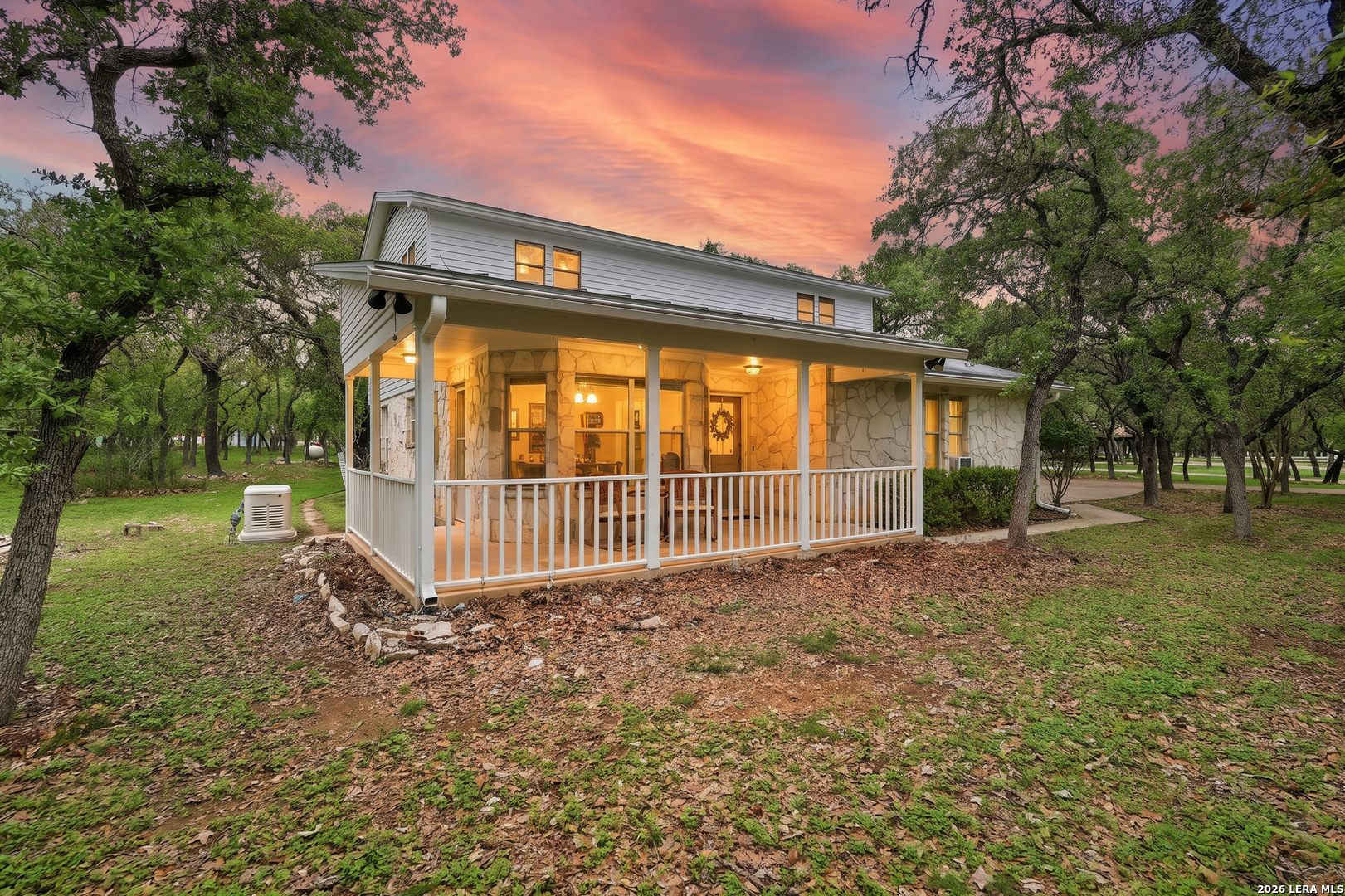 261 Fawn Lane Spring Branch, TX 78070 - Photo 1 of 44 a view of a small yard with wooden fence and large trees