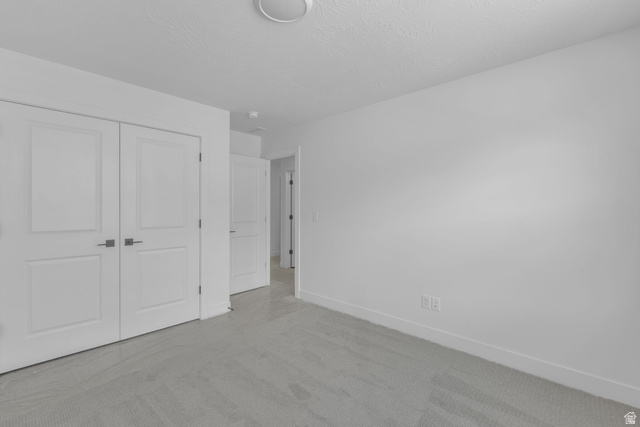 2821 Scarlet Road, Unit 149 Eagle Mountain, UT 84005 - Photo 18 of 28 Bright bedroom featuring closet with double doors.