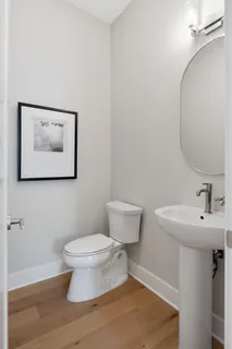 a bathroom with a toilet a sink and a mirror