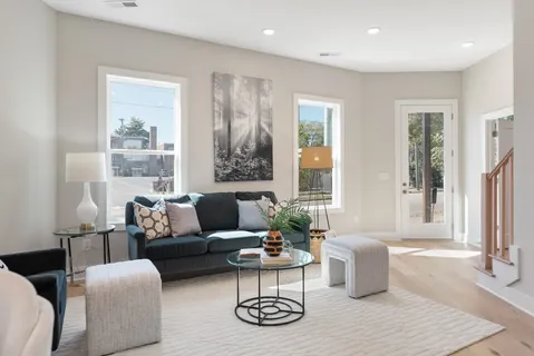a kitchen with stainless steel appliances granite countertop a sink a stove a refrigerator cabinets dining table and chairs