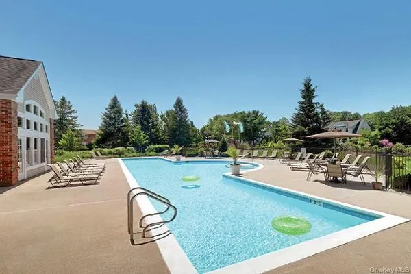 swimming pool view with a seating space