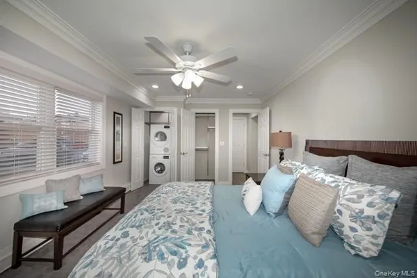 a bedroom with bed and a large window