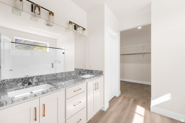 1510 West 600 North, Unit GE 04 Mapleton, UT 84664 - Photo 14 of 21 Double vanity featuring white cabinetry, bronze hardware, and a granite-style countertop