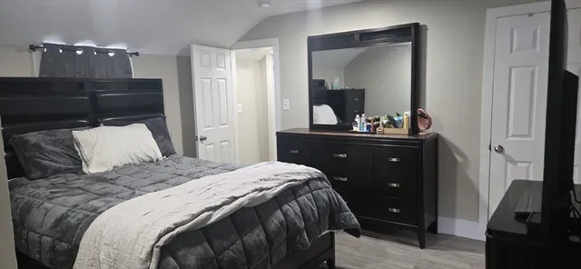 a bedroom with a bed and a mirror
