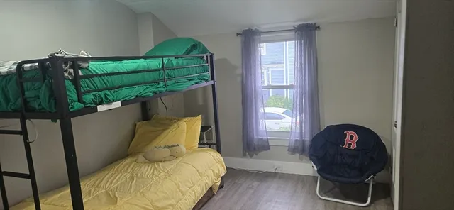 a bedroom with a bed and window