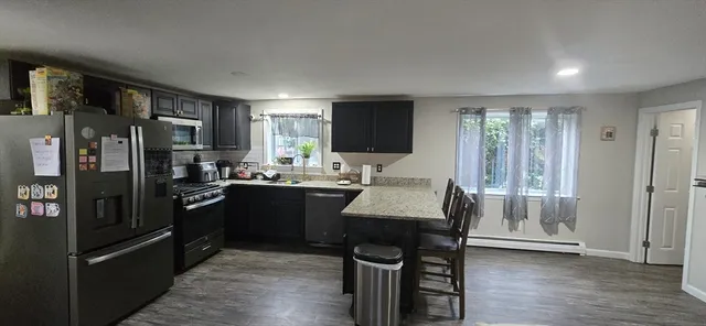 a kitchen with stainless steel appliances granite countertop a refrigerator stove top oven and sink