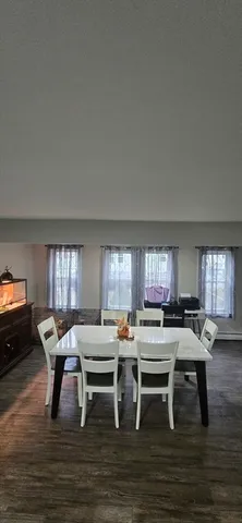a living room with chairs furniture and a window