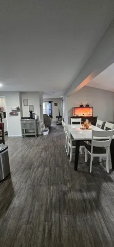 a living room with furniture and a piano