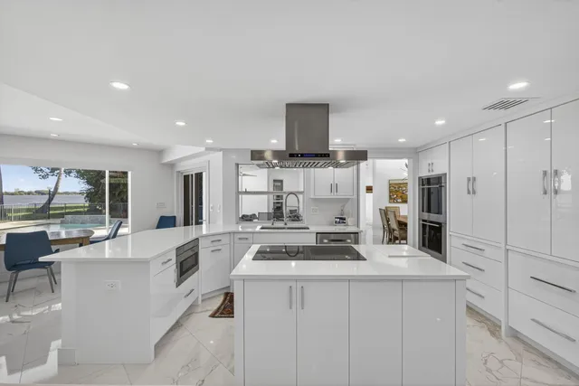 a dining room with furniture and a floor to ceiling window
