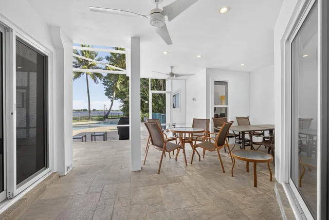 an aerial view of residential house with outdoor space and trees all around