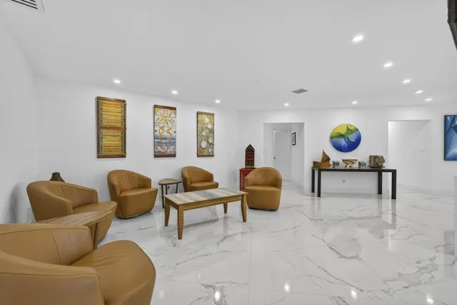 a large white kitchen with a stove a sink and a refrigerator