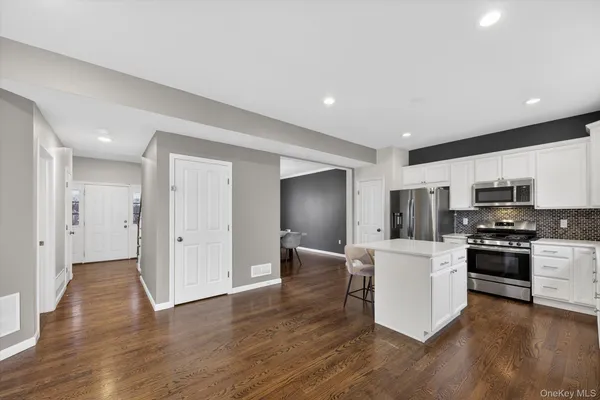 a kitchen with stainless steel appliances a refrigerator sink and stove top oven