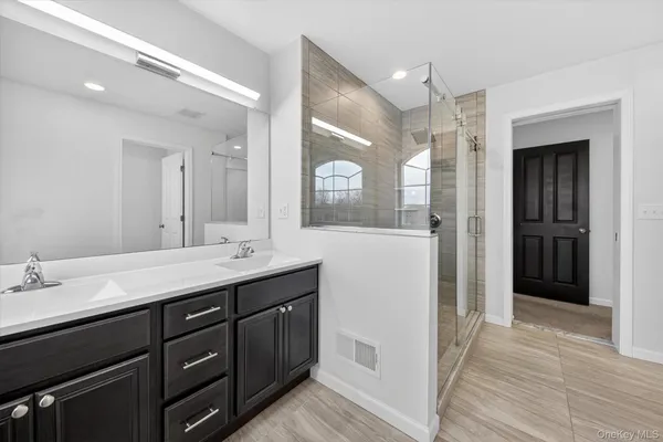 a bathroom with a double vanity sink and a mirror