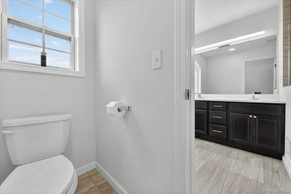 a bathroom with a toilet sink and mirror