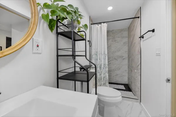 a bathroom with a toilet sink and shower