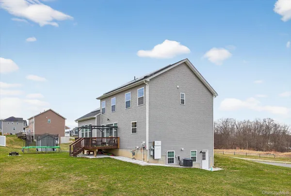 a view of a house with a yard and sitting area