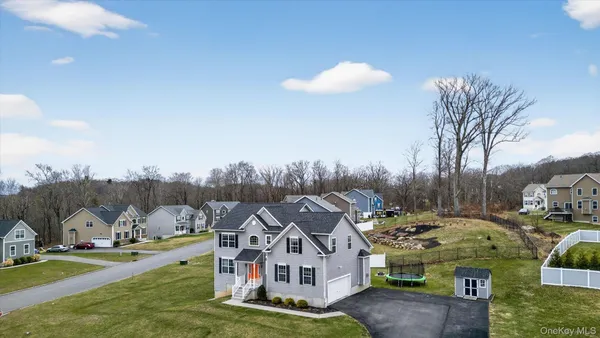 a view of residential houses with yard and mountain view in back