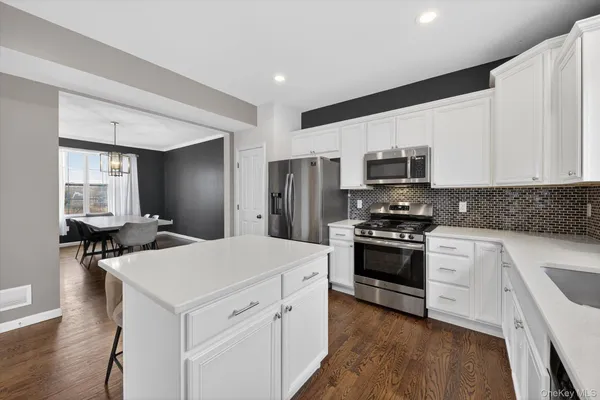 a kitchen with a stove a sink and a refrigerator