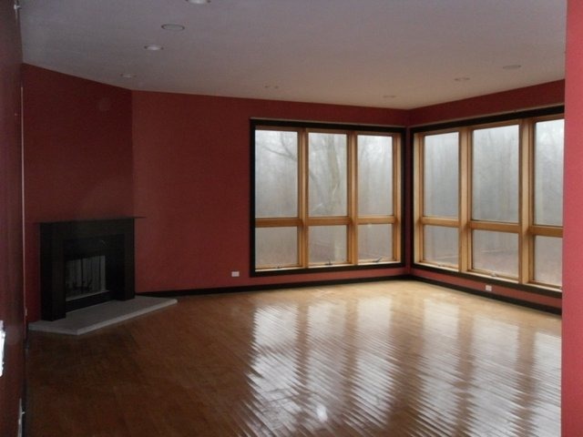 132 Old Dundee Road Barrington, IL 60010 - Photo 11 of 22 a view of an empty room with wooden floor and a window