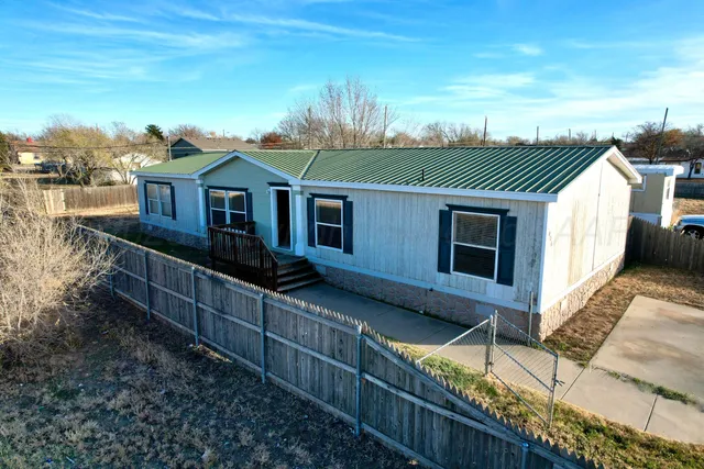 a view of a house with wooden fence