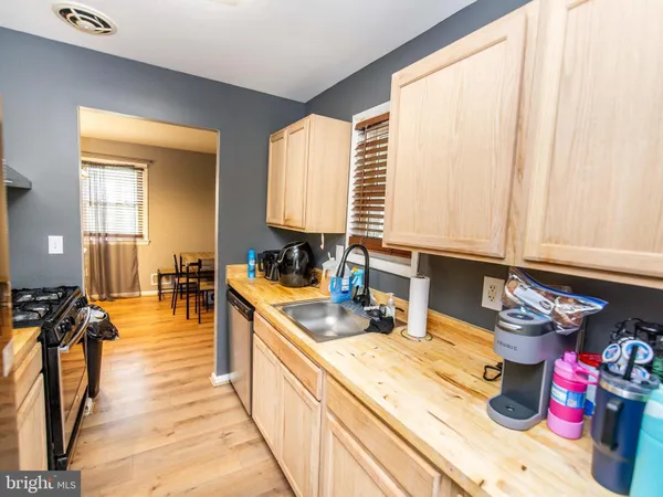 a kitchen with stainless steel appliances a sink a stove and a window