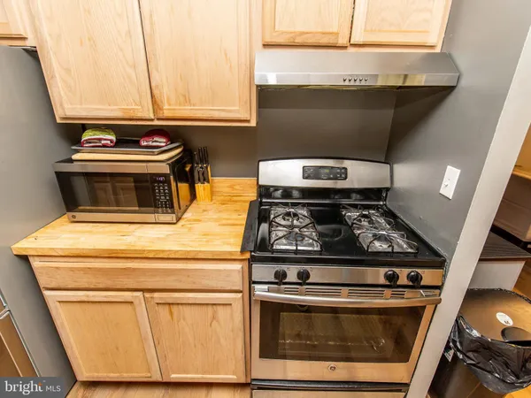 a stove top oven sitting inside of a kitchen