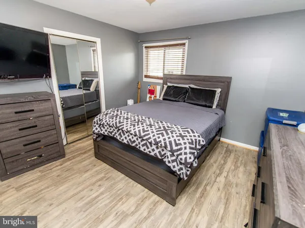 a bedroom with a bed and flat screen tv