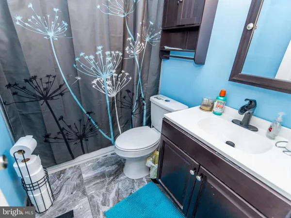 a bathroom with a sink a toilet and a mirror