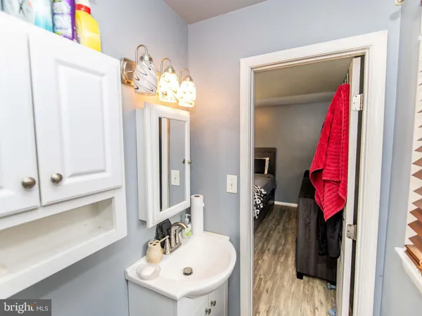 a bathroom with a sink vanity and a mirror