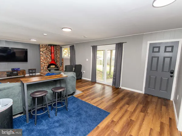 a living room with a table chairs and a flat screen tv