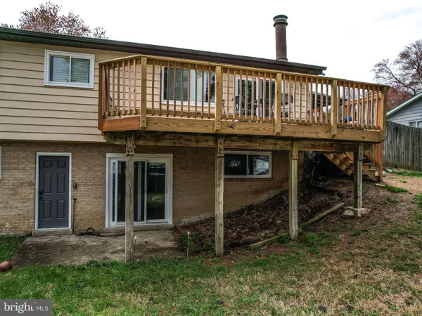 a view of a yard with wooden fence